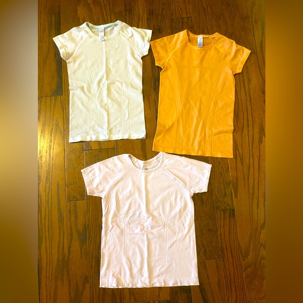 Set of three girls Ivivva by Lululemon and Athleta shirts